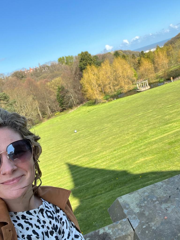 Wedding singer melody poses for a photo in front of the beautiful countryside views of Rushpool Hall 